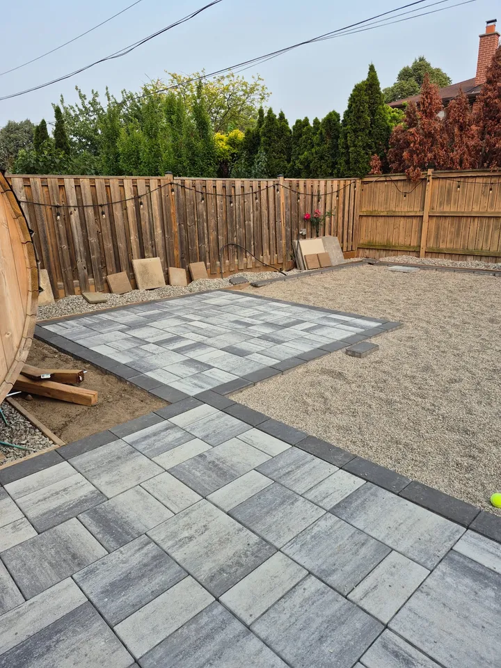 Paver pattern and contrasting borders during installation, with part of the base still exposed.