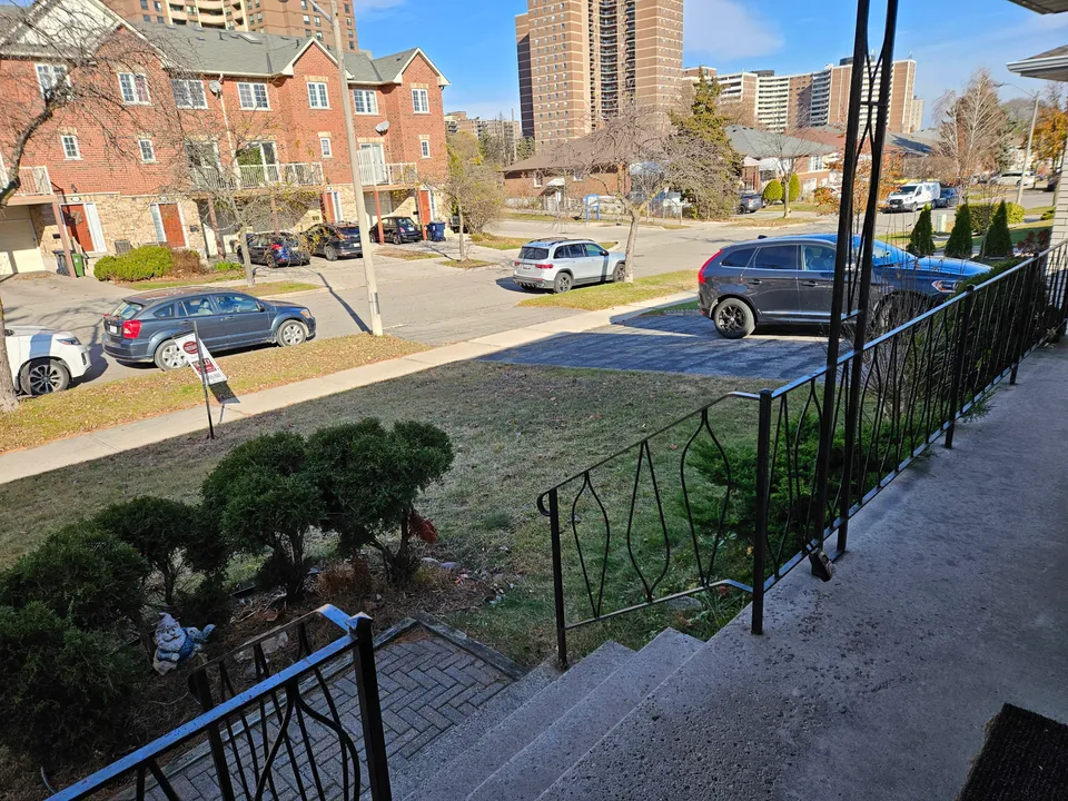Front yard before renovation, with the original lawn and shrubs beside the entrance steps.