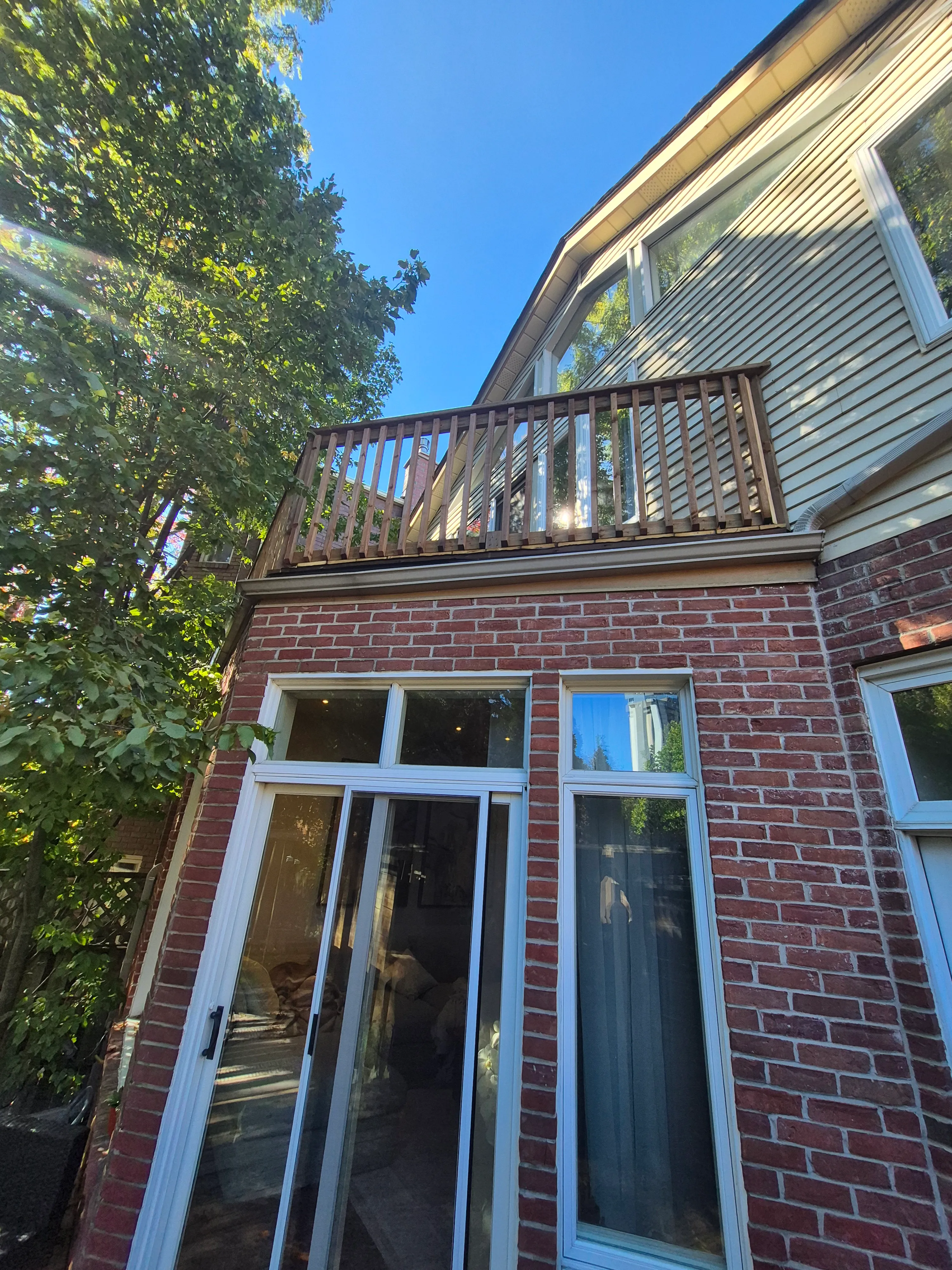 Rebuilt upper deck with timber railings above a brick extension.